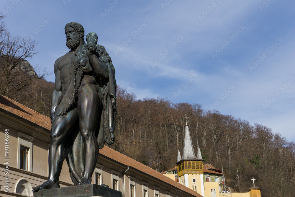 Baile Herculane, Romania - 01.01.2018: Statue of Hercules in the main square of the town. The resort is named after the legendary greek hero that stopped here to bath according to myth.
