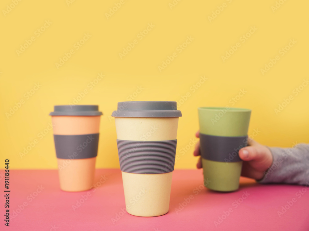 Take away coffee cups on colorful paper background. Take away coffee cups on colorful paper background.