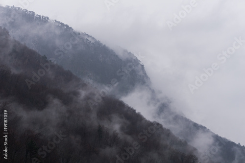 Mist rising from the forested mountains of the Domogled - Valea Cernei National Park after a heavy rain