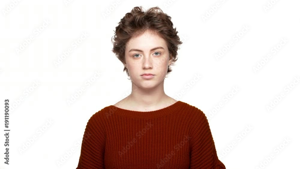 Portrait of woman with short hair throwing both hands up meaning oops sorry, have no idea over white background in studio. Concept of emotions Portrait of woman with short hair throwing both hands up meaning oops sorry, have no idea over white background in studio. Concept of emotions
