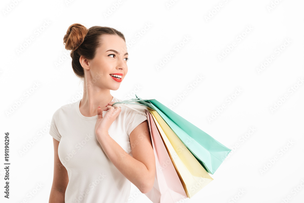 Portrait of a smiling casual girl holding shopping bags Portrait of a smiling casual girl holding shopping bags