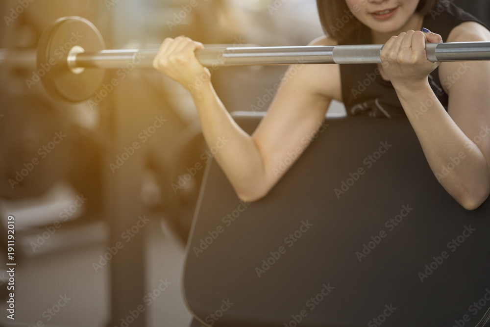 Woman exercising in fitness gym for good health. Athletic young woman exercising equipment at gym, workout in fitness center. Woman exercising in fitness gym for good health. Athletic young woman exercising equipment at gym, workout in fitness center.