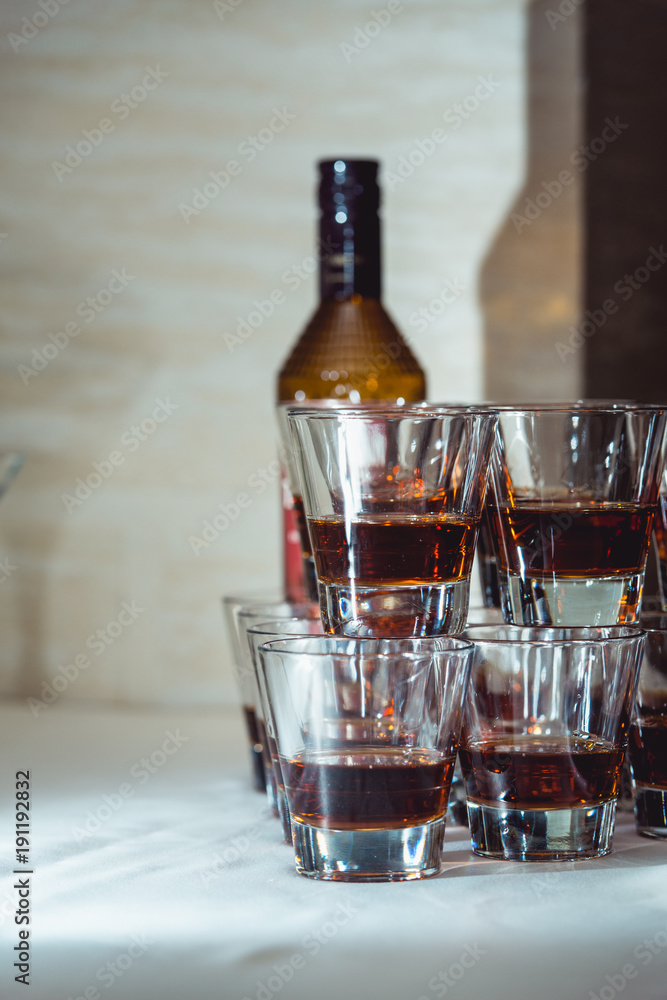 Pyramid of glasses of alcohol made in a pyramid for event party or wedding ceremony Pyramid of glasses of alcohol made in a pyramid for event party or wedding ceremony