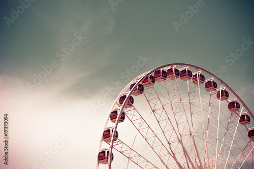 Vintage style Ferris wheel with blue sky