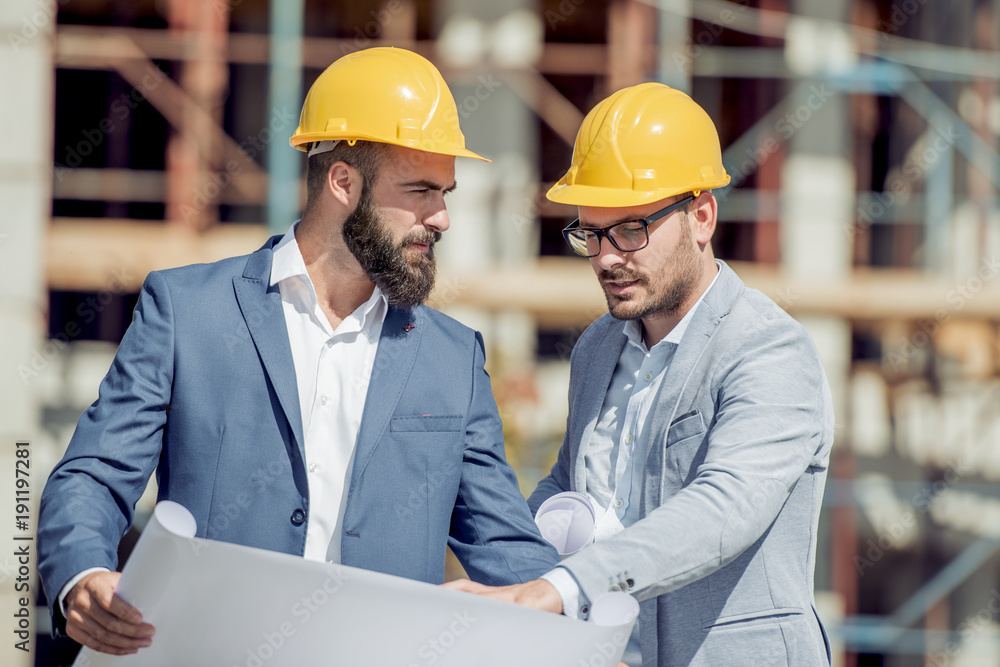 Construction specialist and worker outdoors. Construction specialist and worker outdoors.