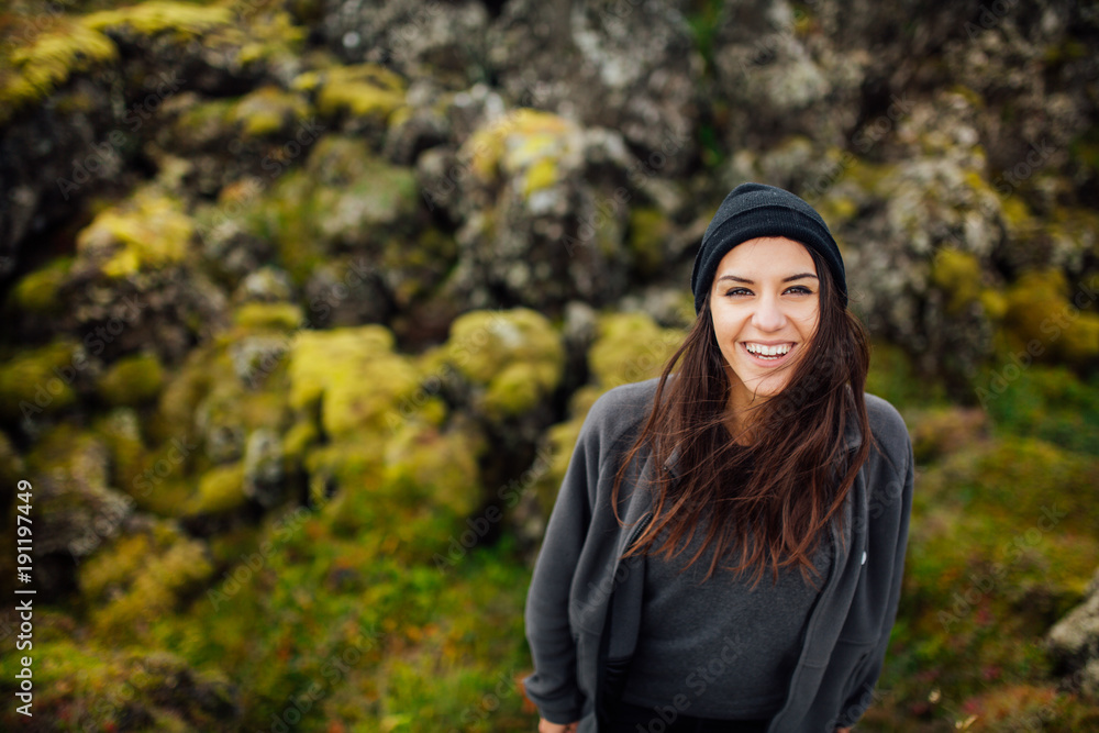 Young peaceful woman enjoying view of the moss covered meadows in Iceland.Arctic circle wild nature.People and nature connection.Female wearing comfortable camping/hiking clothes.Traveling and camping Young peaceful woman enjoying view of the moss covered meadows in Iceland.Arctic circle wild nature.People and nature connection.Female wearing comfortable camping/hiking clothes.Traveling and camping