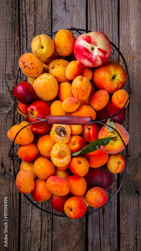 Apricots, Fruits in a metal basket on a vintage wooden background.Food or Healthy diet concept.Super Food.Vegetarian.Top View.Copy space for Text.selective focus.
