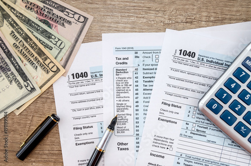 1040 Tax form, dollar and calculator