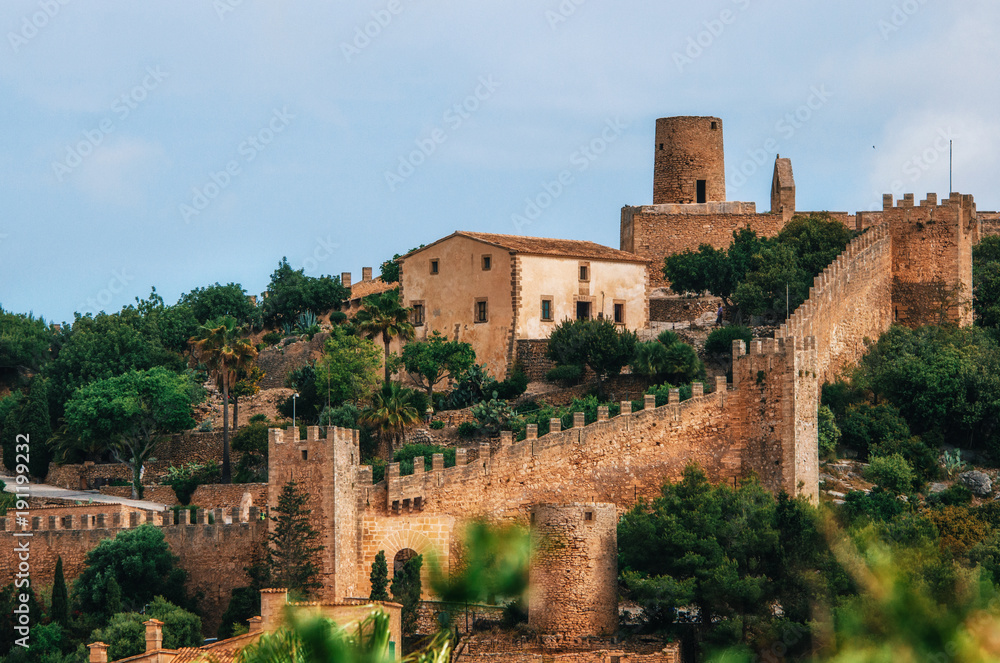 Capdepera castle on green hill in Mallorca island, Spain. Beautiful landscape with medieval architecture in Majorca
