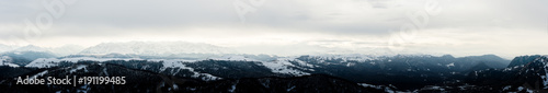 Panorama of the Caucasian ridge with clouds hanging on tops of mountains © yanik88