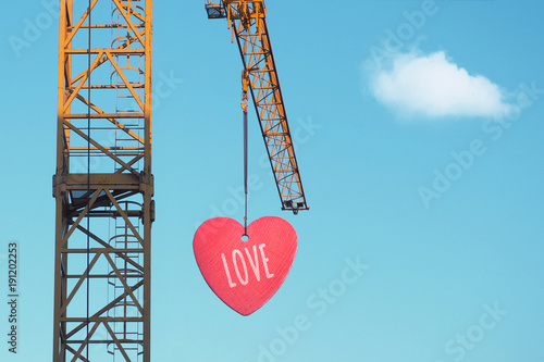 Bild auf Leinwand Love is in the air - crane with heart attached