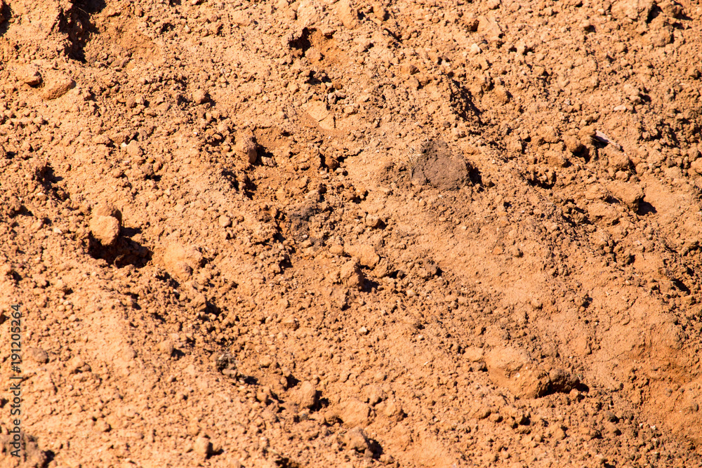Red clay soil on nature as a background Red clay soil on nature as a background