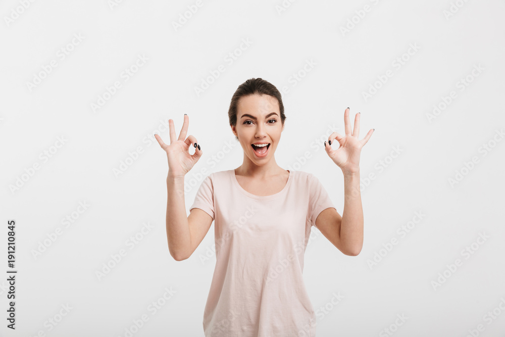 happy girl showing ok gesture with two hands isolated on white happy girl showing ok gesture with two hands isolated on white