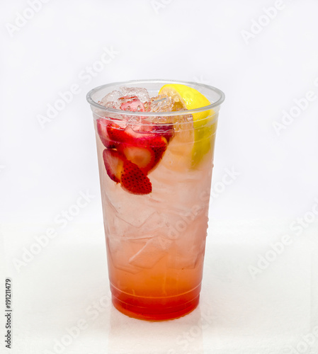 Strawberry Lemonade in a clear plastic cup on a white background.