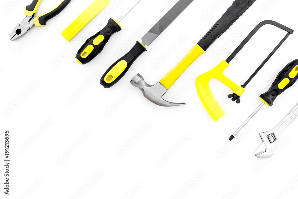 Tools for repair and building. File, saw, hummer on white background top view copy space Tools for repair and building. File, saw, hummer on white background top view copy space