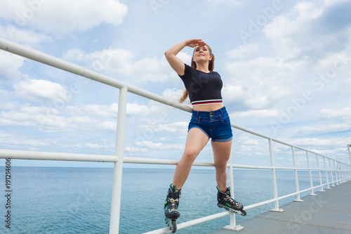 Joyful teen girl wearing roller skates © Voyagerix