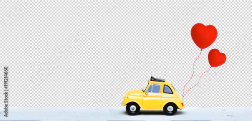 Clipping path. Miniature car with two red heart balloon. concept of love wedding honeymoon