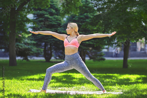 Woman training yoga pose outdoors