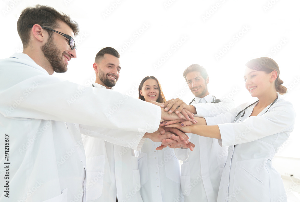 Doctors and nurses in a medical team stacking hands Doctors and nurses in a medical team stacking hands