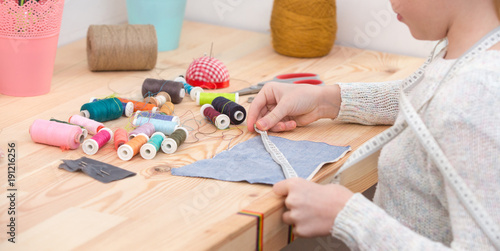 girl sews doll clothes, Child sewing 