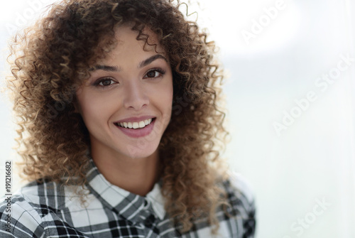 Portrait of a beautiful young woman with curly hair. © ASDF