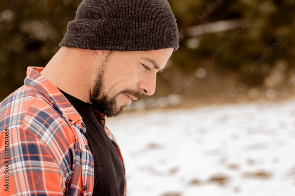 Pensive man with beard,plaid t-shirt,hat and casual clothes. A young and carefree lifestyle. Pensive man with beard,plaid t-shirt,hat and casual clothes. A young and carefree lifestyle.