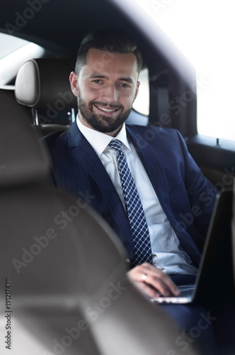 Close-up of a successful businessman sitting in a car