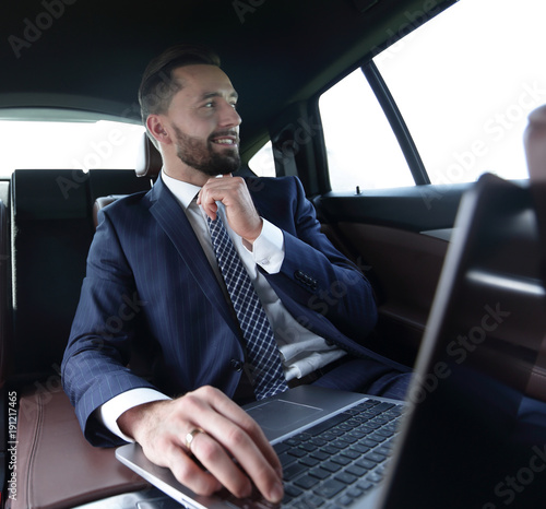 Confident businessman sitting in car © ASDF