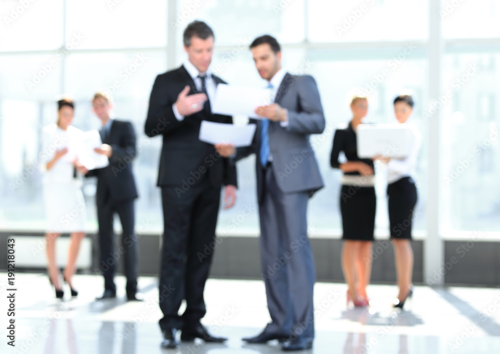 image is blurred. business partners discuss the working papers. image is blurred. business partners discuss the working papers.