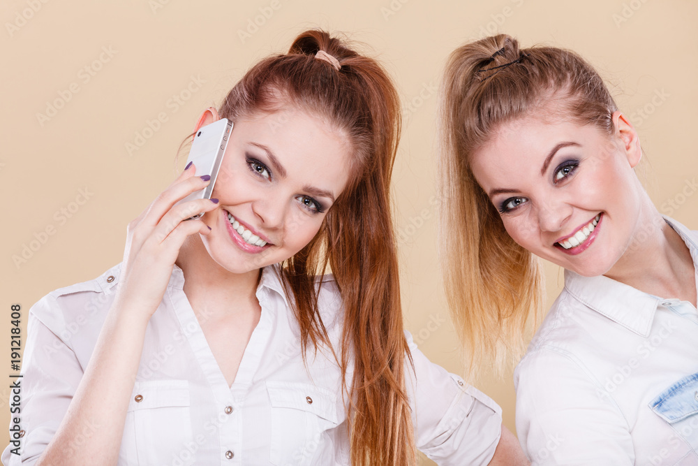 Girls using mobile phone talking Girls using mobile phone talking