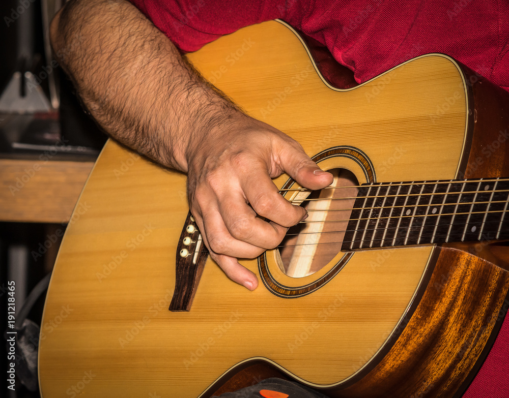 Fototapeta premium Man playing acoustic guitar