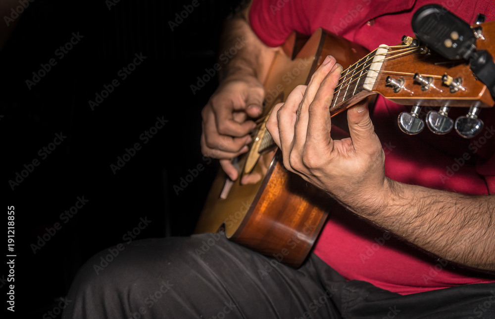 Fototapeta premium Man playing acoustic guitar