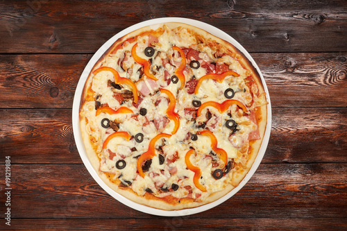 Fresh baked pizza on wooden background