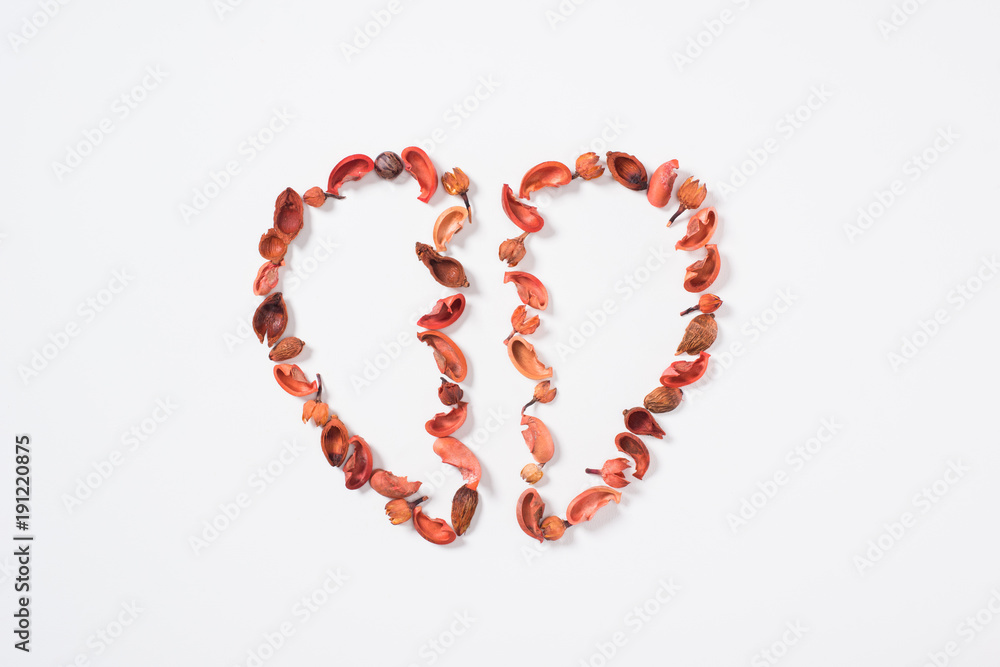 top view of two halves of heart from dried fruits isolated on white, valentines day concept top view of two halves of heart from dried fruits isolated on white, valentines day concept