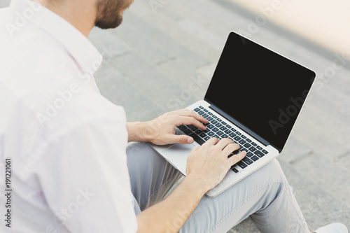 Male hands with laptop, over shoulder shot
