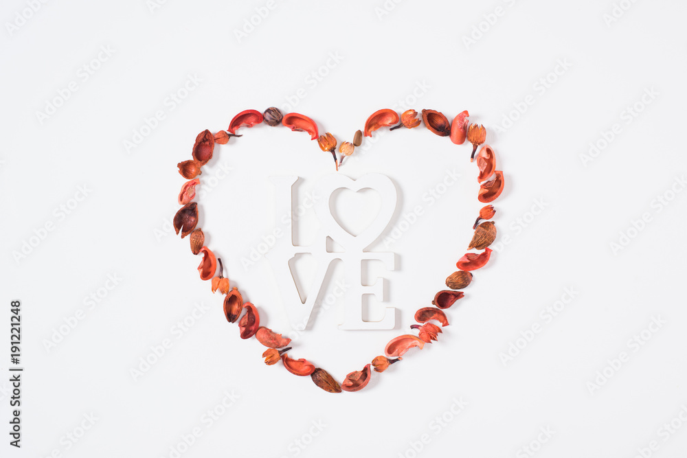 top view of heart from dried fruits with word love isolated on white top view of heart from dried fruits with word love isolated on white