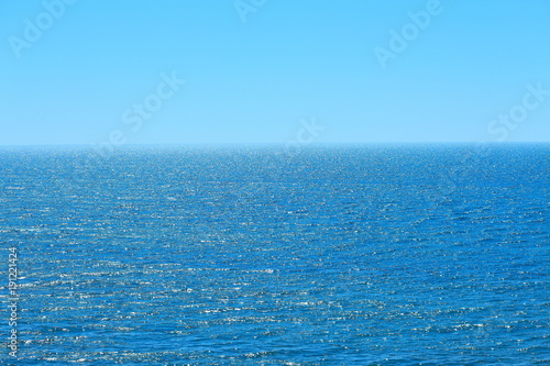 Calm sea and blue clear sky. Bright sky and water. Abstract composition