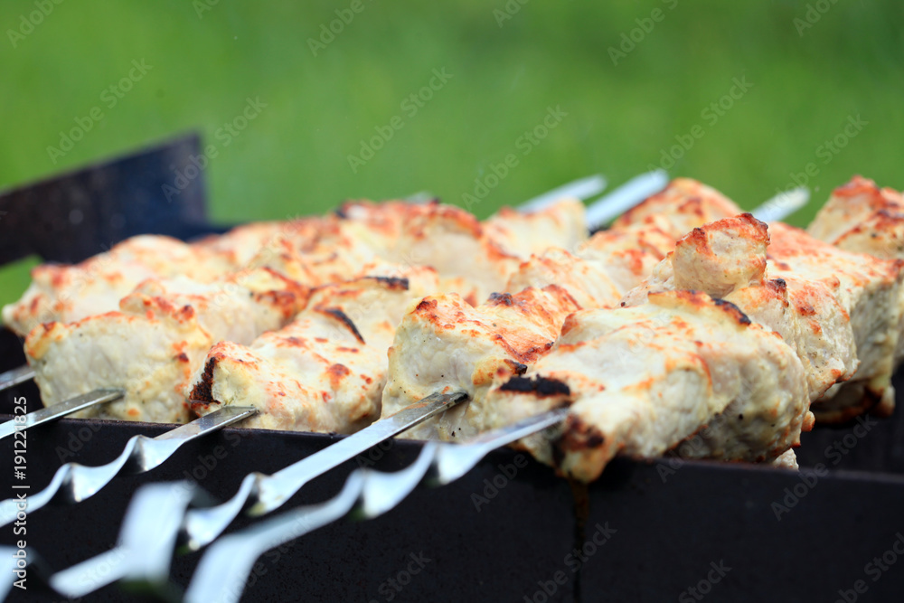 Meat skewers on grill. Background green grass. Tasty. Meat skewers on grill. Background green grass. Tasty.