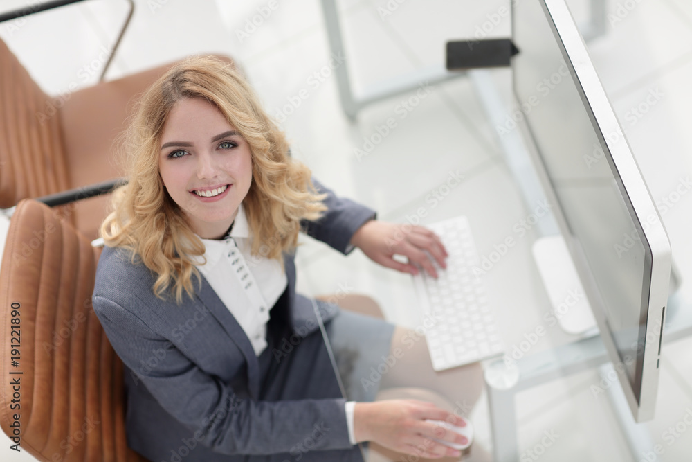 smiling business woman sitting behind a Desk smiling business woman sitting behind a Desk