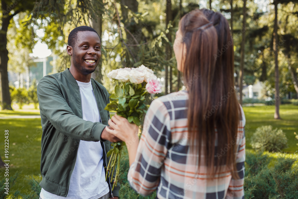 Man giving flowers for his beautiful girlfriend Man giving flowers for his beautiful girlfriend