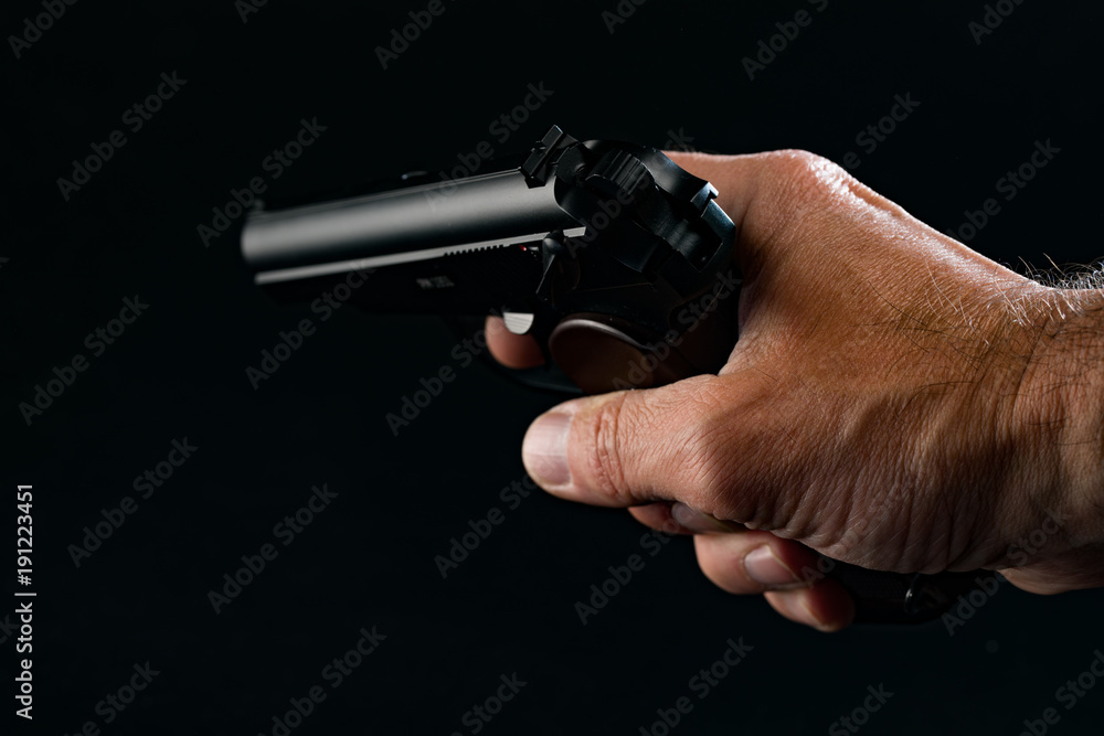 Male hand with gun