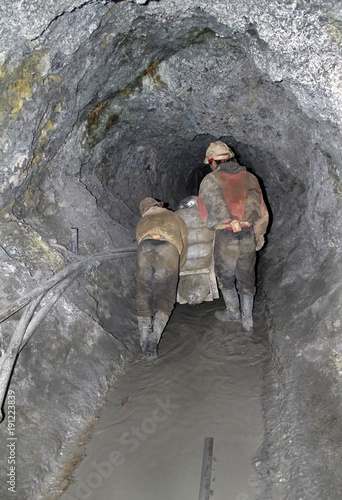 Miners in a dark quarry in Potosi, Bolivia photo