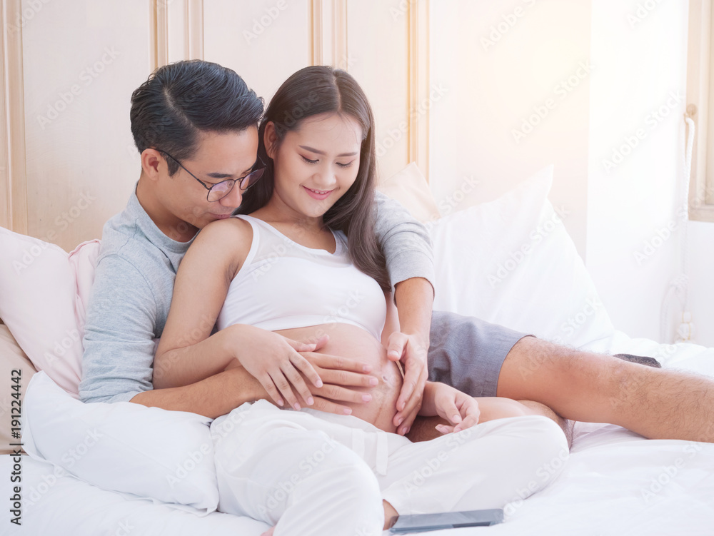 Happy pregnant woman and her husband waiting for baby, happy family love and care. Happy pregnant woman and her husband waiting for baby, happy family love and care.