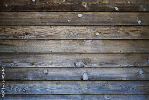 Dark neutral brown wood background with horizontal lines. Flat wooden panels with grain and knots.