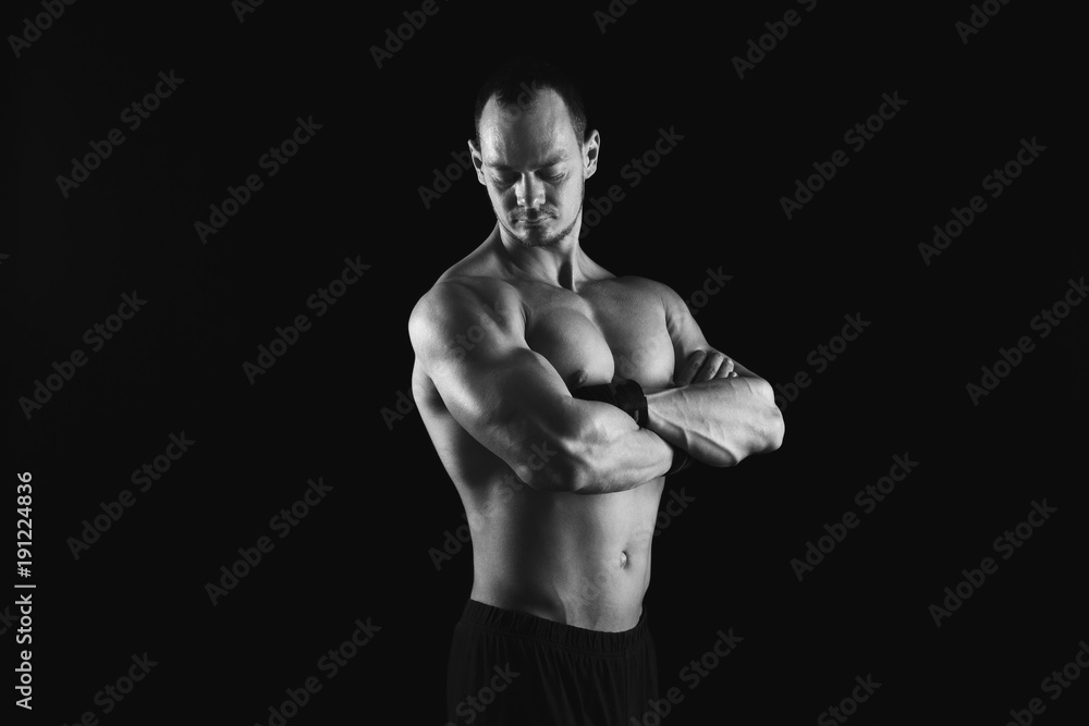 Strong athletic man showes naked muscular body Strong athletic man showes naked muscular body