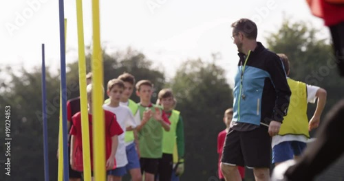 Soccer coach psyching up a young player during training session.Shot on RED Epic photo