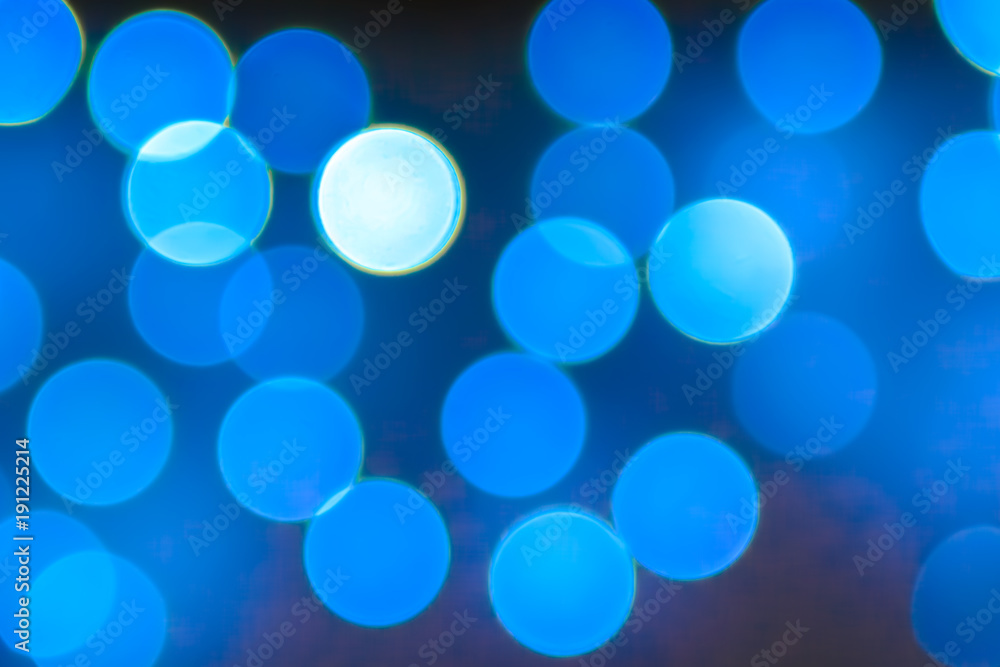 Texture from the blurred blue circles in bokeh style for design. Defocused lights of the city. Texture from the blurred blue circles in bokeh style for design. Defocused lights of the city.