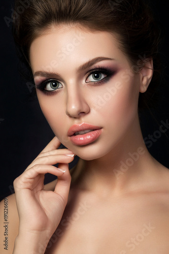 Portrait of young woman with evening make up
