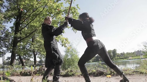 Man and woman are fighting sword on the bridge photo