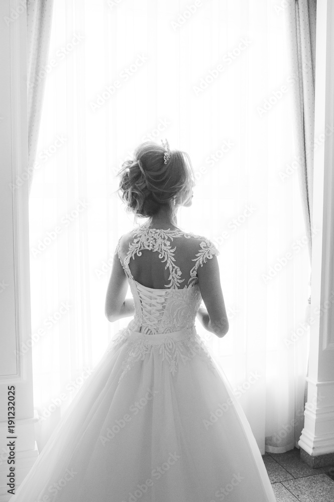 Beautiful bride in wedding dress before wedding ceremony in great hall